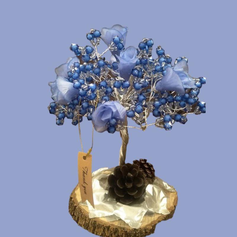 A Decorative Blue Tree With A Wooden Base