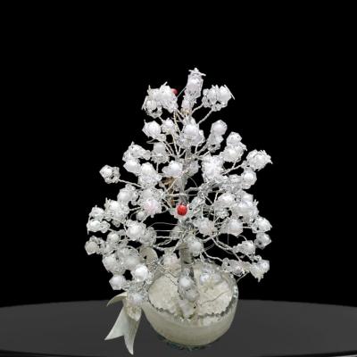 A Decorative White Tree With A Glass Base