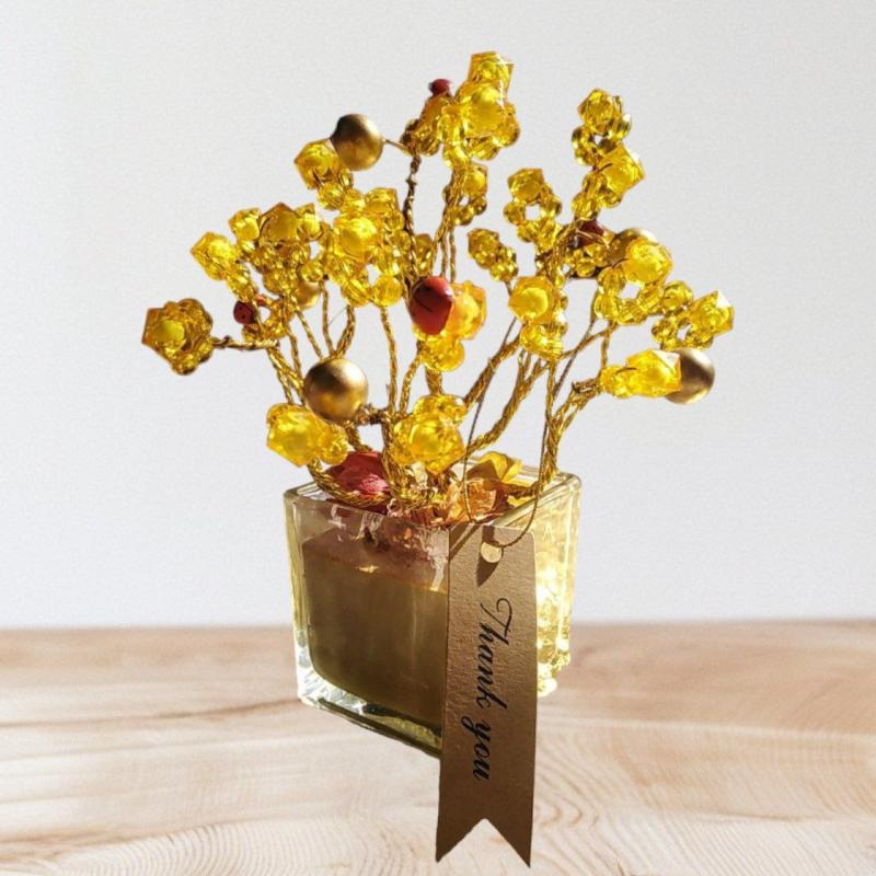 A Decorative Gold Tree With A Glass Base